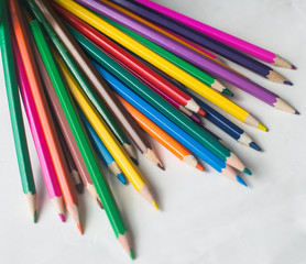 colored pencils and felt-tip pens on a white background