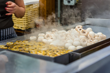 Cooking mushrooms in a kitchen.