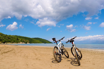 Fototapeta na wymiar Two bicycles on the beach. Corfu island. Greece.
