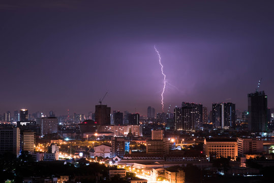 Lightning storm over city in purple light