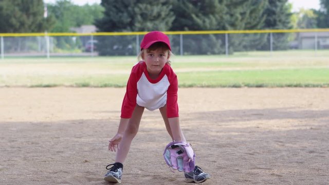 Little girl throwing baseball