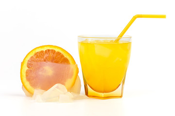Glass of orange juice and fruit frozen inside ice isolated on white