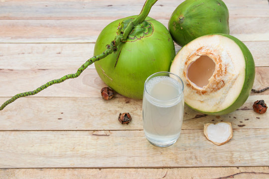 Fresh Coconut Water Drink in glass on wooden  background