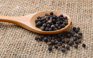 pepper corn in wood spoon