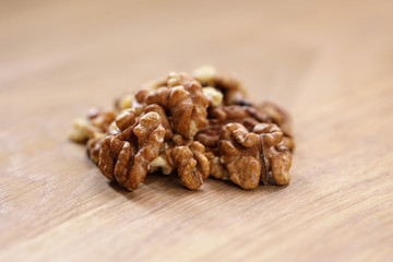 walnut kernels on aok wood table close up