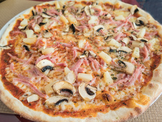 Pizza with ham, pineapple, mushroom topping