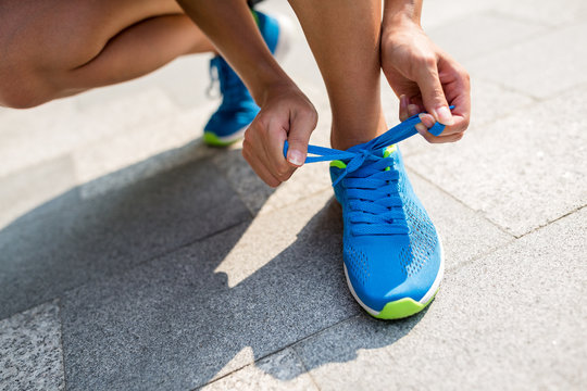 Woman fixing runnning shoes