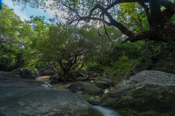 Sunray on Deep forest waterfall with rocks  in rainy season at Tadton waterfall National Park Thailand -  Fantasy jungle landscape
