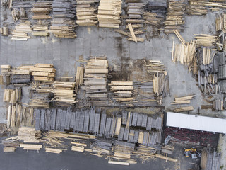 Sawmill. Felled trees, logs stacked in a pile. View from above.