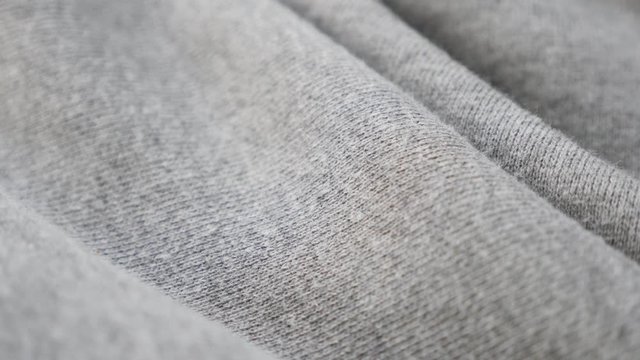 Gray sweat shirt or pants fine fabric texture close-up 4K 2160p 30fps UltraHD tilting footage - Cotton and polyester pattern of training cloth slow tilt 4K 3840X2160 UHD video