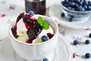 Vanilla ice cream with blueberry jam in a cup