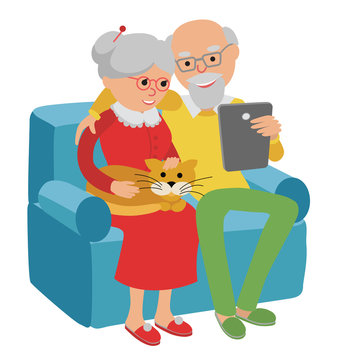 Happy senior couple sitting on the sofa read with tablet.