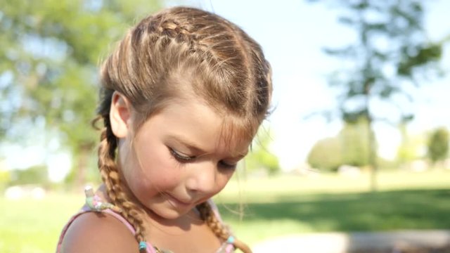 Closeup of little girl in park