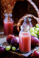 Freshly squeezed smoothie from green grapes and sweet ripe plums