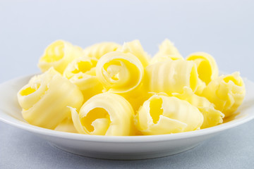 Fresh butter curls on dish closeup