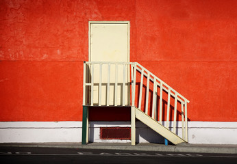 door and stair on orange wall
