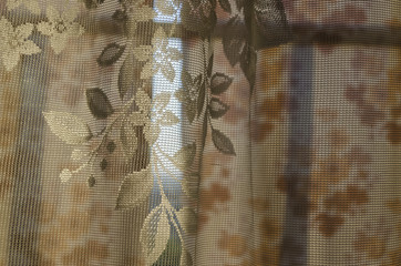 Sunlight shining through the window from the garden. Through the tulle and curtains