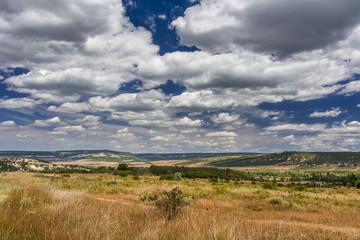 Fototapeta premium Mountain valley with a cloudy sky. Natural summer landscape.