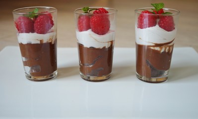 Vegan chocolate mousse with whipped coconut cream and fresh raspberries