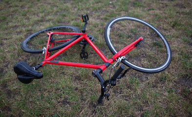 Fototapeta na wymiar Red bike lying on grass