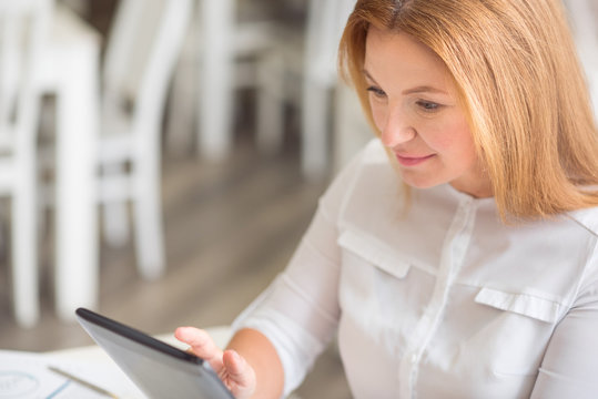 Pleasant content woman using tablet