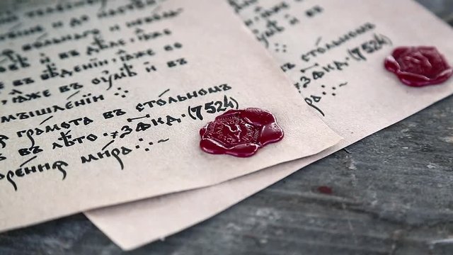 Old papers lies on the table. Antique letters with official heraldic stamps. Two ancient manuscripts