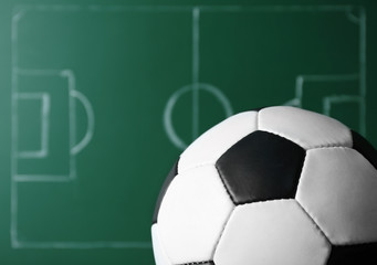 Football game strategy written with chalk on blackboard