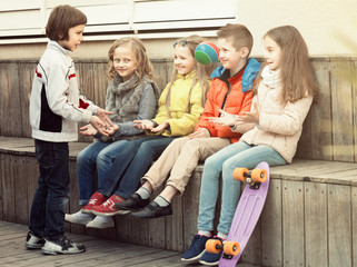 Happy kids with small ball playing in street