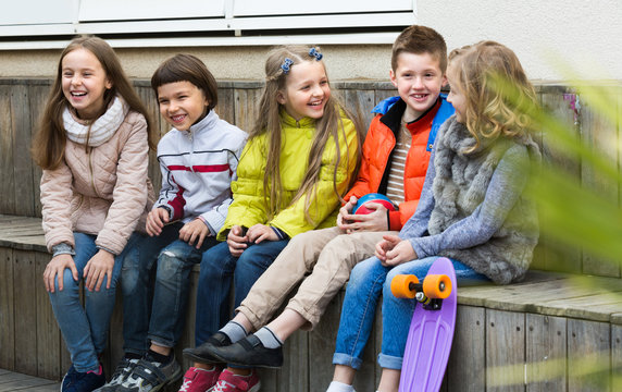 Junior kids chatting outdoor .