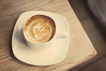 Cup of fresh coffee on the table