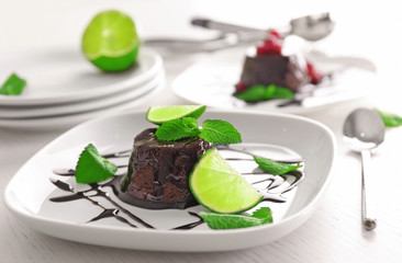 Chocolate fondant cake with mint and lime on the plate