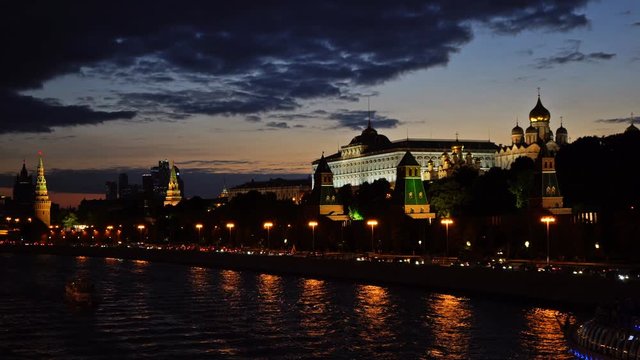 Moscow Kremlin, Moskva River quay, Grand Kremlin Palace, Cathedral of the Annunciation,  Cathedral of the Archangel and the skyscrapers. Sunset. UHD - 4K. August 26, 2016. Moscow. Russia
