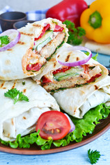 shawarma Lavash with chicken, tomatoes, lettuce and peppers on a
