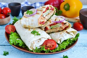 shawarma Lavash with chicken, tomatoes, lettuce and peppers on a
