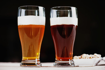 Glasses of beer and pistachio nuts 
