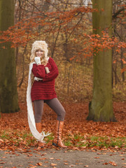 Fashion woman in windy fall autumn park forest.