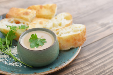 Hummus in bowl with parsley
