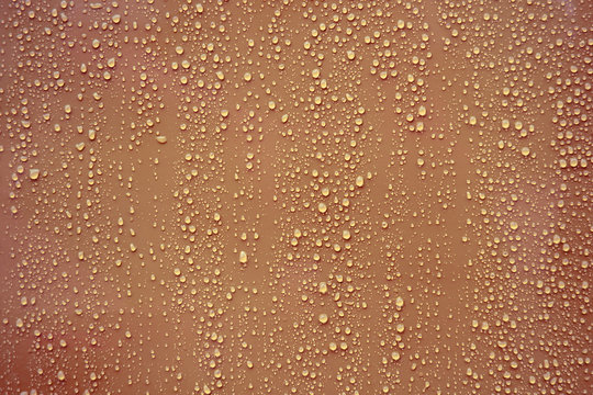 Water drop on brown background.