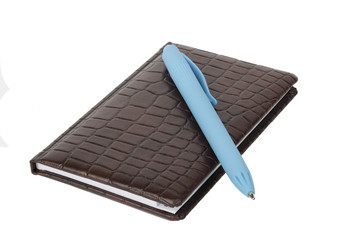 Brown leather notebook with blue pen isolated on white