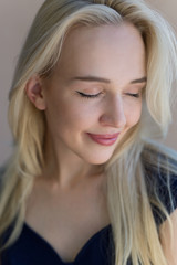 A portrait of a beautiful blonde woman smiling.