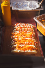 Chef prepares a lot of hot dogs