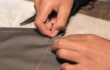 Production process of suit tailoring, hand sewing of a tailored jacket
