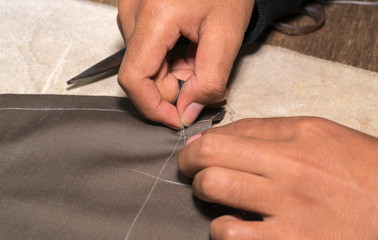 Obraz premium Production process of suit tailoring, hand sewing of a tailored jacket 