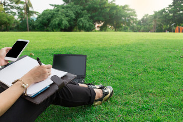 Notebook Computer mobile woman,people lifestyle sitting at the park