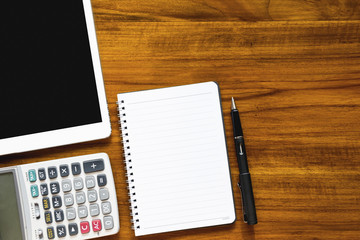 Flat lay photo of work desk with  pen, laptop, tablet, mouse, calculator and chart paper mock up.