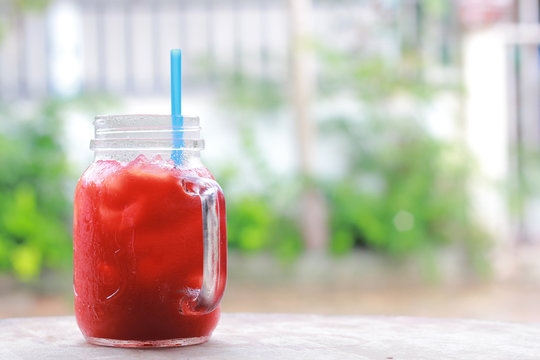ice tomato juice in cup on background