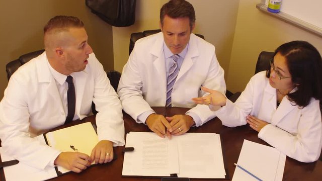 Three doctors discussing in meeting