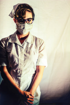 Nurse With Mask Vintage. Classic Female Nurse In Authentic Vintage Uniform And Mask. Edited In A Vintage Film Style.