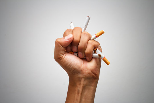  Male hand crushing cigarette, Concept Quitting smoking,World No Tobacco Day