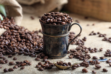 Coffee beans and a cup on a burlap